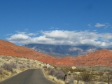 The Red Cliffs National Recreation Area access road. The Pine Valley Mountains are visible in the background as well as the Orson Adams pioneer residence built in the mid 1800's.